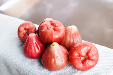 A bunch of Rose apples or chomphu fruit on a table