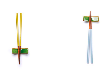 A sushi chopsticks and a small bowls, elegantly arranged on a clean white background