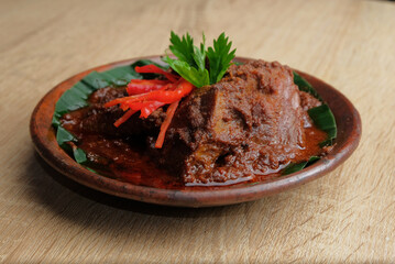 rendang beef on a wooden table