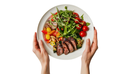 Chef holding plate with healthy grilled steak, vegetables and salad on transparent background