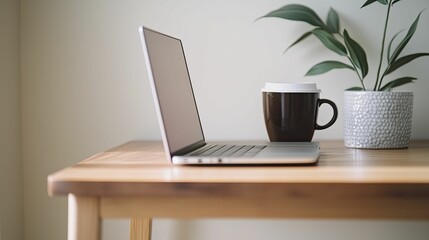 A sophisticated laptop on a wooden desk, paired with a stylish coffee cup and a planner, conveying the essence of focused work and planning.