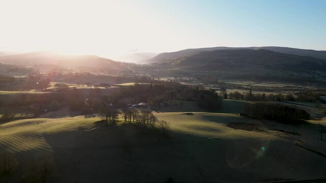 Stunning Drone footage of sunrise in the Yorkshire Dales above the village of Sedbergh. Dawn sunrise above the hills and misty landscape of the Yorkshire dales national Park.