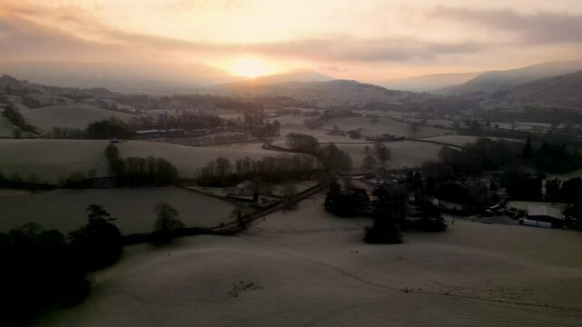 Stunning Drone footage of sunrise in the Yorkshire Dales above the village of Sedbergh. Dawn sunrise above the hills and misty landscape of the Yorkshire dales national Park.