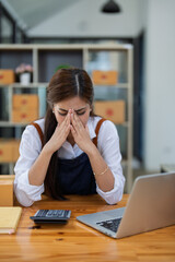 Young woman engaged in online business with stress thoughtful within data products Sales did not meet target Selling products of This month