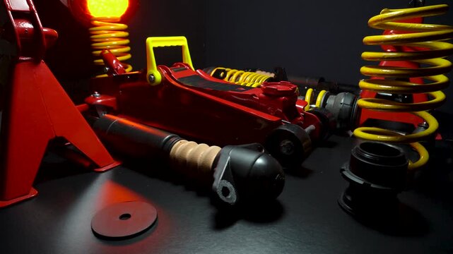 tuned new parts spare parts for the front suspension of a front-wheel drive car ball silent blocks coilovers yellow and a jack with stands