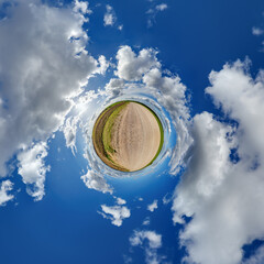 simple little tiny planet without buildings in blue sky with sun and beautiful clouds....