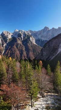 Vertical aerial drone view of Supca viewpoint in Slovenia with mountains, lush forests and stunning skies.