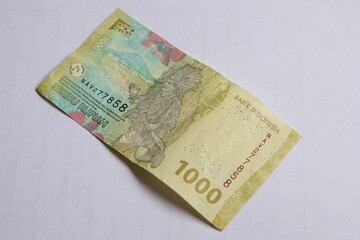 Indonesian Rupiah banknote isolated on a white background. The image captures details of the currency, including texture, colors, and security features. Suitable for financial and economic themes.