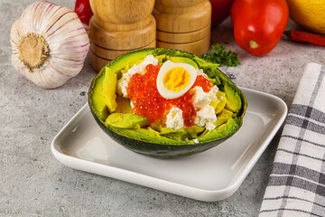 Avocado with red caviar and quil egg