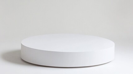 A minimalist white cylindrical platform on a white background.