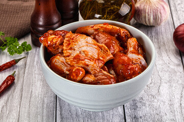 Raw marinated buffalo chicken wings