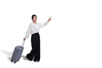 Cheerful young Asian woman holding suitcase with walking to the front, isolated on white...