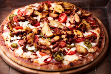 Gyros Pizza with jalapeno pepper, cherry tomatoes and mozzarella cheese. Soft focus. Close up.
