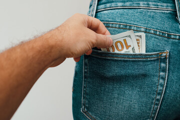Money in the pocket. Stealing money Concept finance with Bundle of dollar. Human hand taking money...