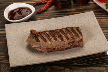 Grilled beef striploin steak with sauce