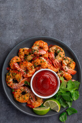 grilled shrimps served with lime, coriander leaves and tomato sauce