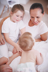 Children, mother and relax together in home, love and learning talking skills in bedroom for growth. Development, infant and security in relationship, conversation and support with new skill
