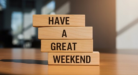 wooden blocks stacked vertically on a wooden surface, displaying "HAVE A GREAT WEEKEND" in bold black letters. Warm lighting and a blurred background create a positive, relaxing vibes
