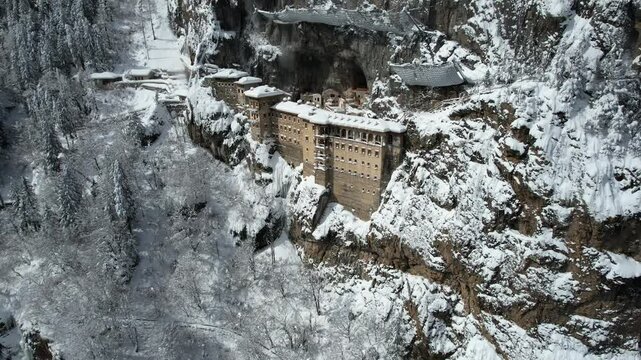 Sumela Monastery, a historic monastery built on the rock, snow-covered view of a monastery, Turkey