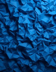 Obraz premium The folded and crumpled surface of the blue paper creates a dynamic and abstract texture