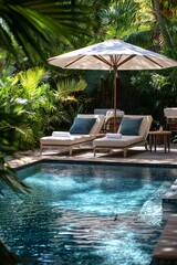 Obraz premium Tropical-style garden with lounge chairs, umbrella, side tables, and coffee table by pool, featuring a poolside café for a relaxing atmosphere.