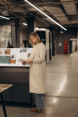 Woman Browsing Through Design Samples in a Modern Studio Environment