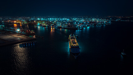 Cruise ship departs from the pier at night, blurred motion concept