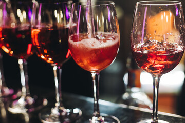 Bartender working, barman mixing and pouring drinks and beverages in a club, beautiful row line of...