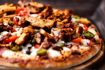 Gyros Pizza with jalapeno pepper, cherry tomatoes and mozzarella cheese. Soft focus.