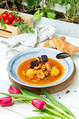 Seafood soup on a wooden board, restaurant.