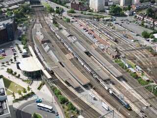 Aerial view of a bustling train station with multiple platforms.