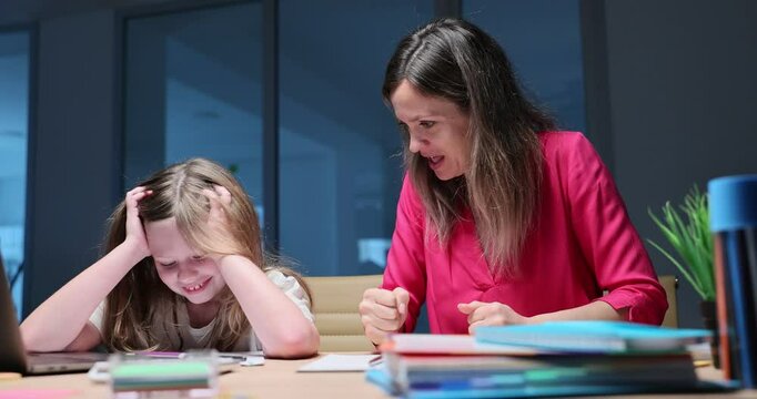Irritated mother tries to explain homework to daughter at desk. Naughty girl covers ears with hands showing unwillingness to do assignment in evening