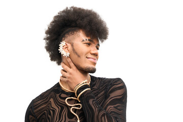 Young androgynous artist wearing gold jewelry and looking away