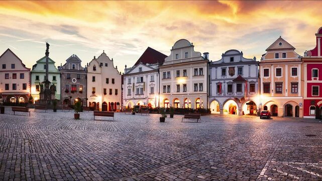 Time lapse - Scenery of the Plaza in Cesky Krumlov, a medieval town in Czech Republic with colorful houses, monument in the square  before sunrise. Czech republic
