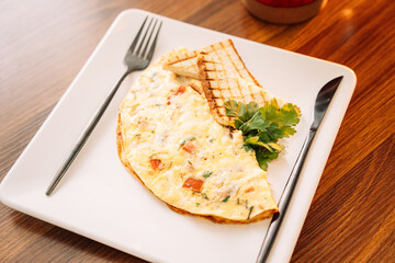 Omelette for breakfast with champignons and sauce.