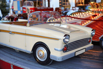 A nostalgic children's carousel with cars © Ina Meer Sommer