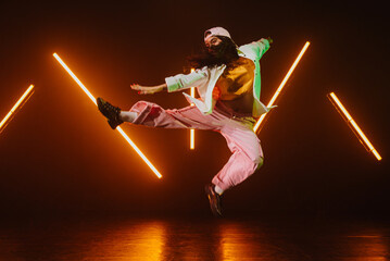 Hip hop dancer dancing in a cool studio with neon lights.
