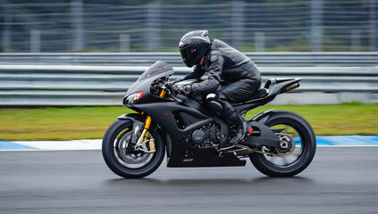 A motorcycle rider dressed in all black leather navigates a racetrack with intense focus on a cloudy day. The rider leans into a turn, showcasing skill and precision