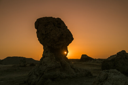 Sun setting behind a salt pillar near lake Afdera in Afar region, Ethiopia