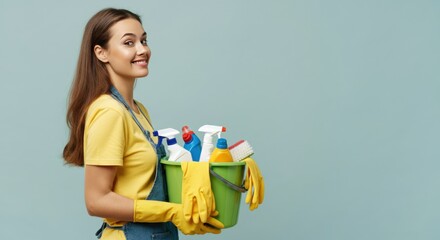 Woman smiling while holding a bucket of cleaning supplies and wearing gloves