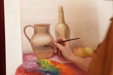 Woman with palette and brush learning to draw, closeup