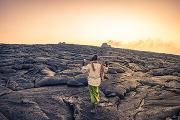 Man walking on solidified lava in Erta Ale volcano crater in Afar region, Ethiopia