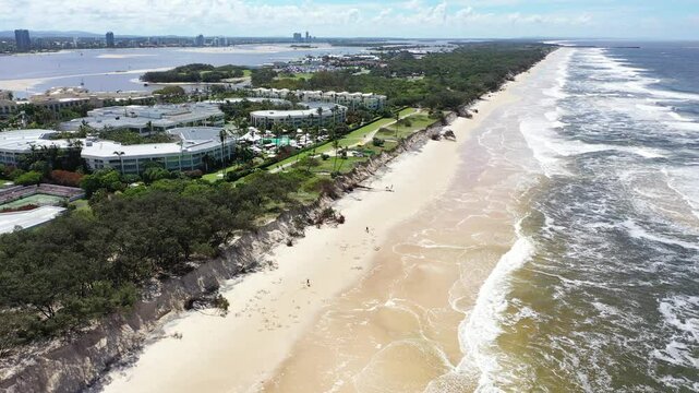 Aerial view looking up the Gold Coast coastline towards the spit, showing the beach erosion and fallen trees after cyclone Alfred  