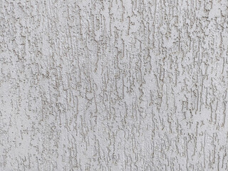 Light beige wall with rough surface plastered with cement. Texture and structure are clearly visible