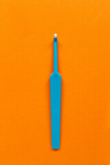 morning and evening routine dental care from caries tool like blue tuft toothbrush on orange...