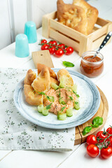 Chicken pate with bread and fresh cucumbers in a plate, restaurant. Vertical frame.