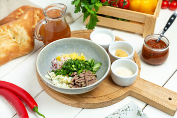 Okroshka with kvass in a plate, restaurant. Horizontal frame.