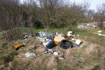 Illegal waste dump in the forest. Ecological disaster. Human stupidity, pollution of our own environment, the planet.
