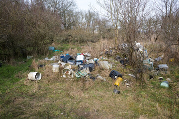 Illegal waste dump in the forest. Ecological disaster. Human stupidity, pollution of our own environment, the planet.
