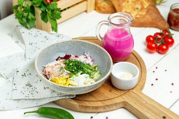 Okroshka with kefir in a plate, restaurant. Horizontal frame.
